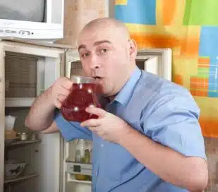 Man drinking from pitcher of cold-brew tea