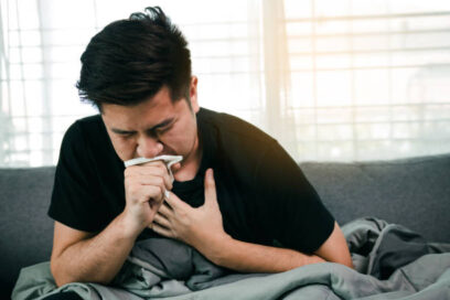 Person holding chest and coughing