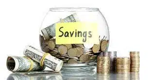 Coins and dollar bills in a Savings jar