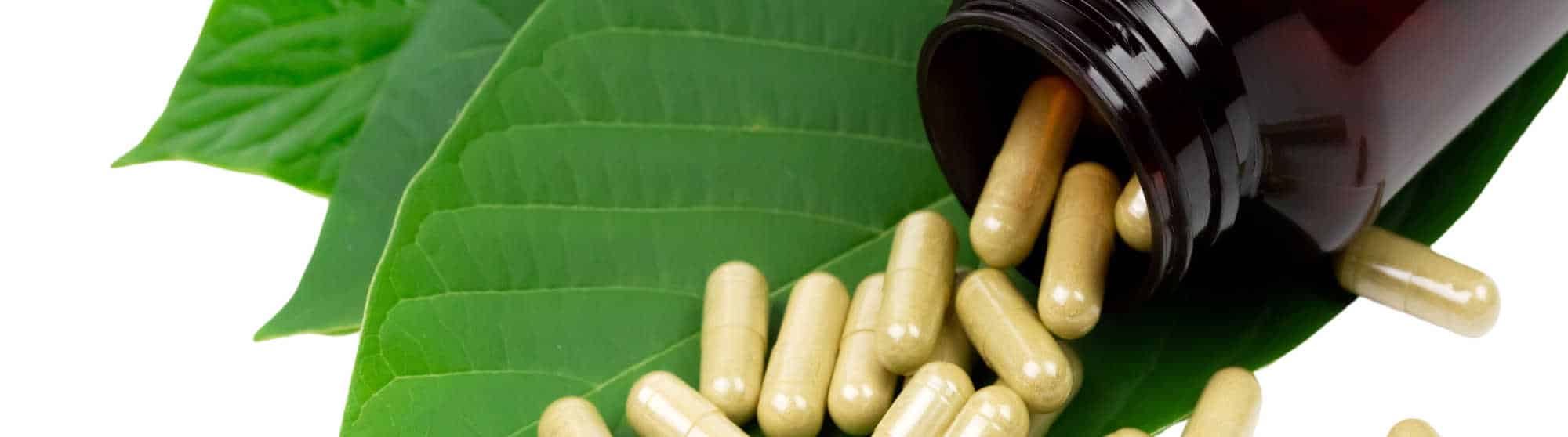 image of kratom capsules and leaves