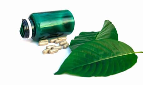 Kratom capsules and leaves